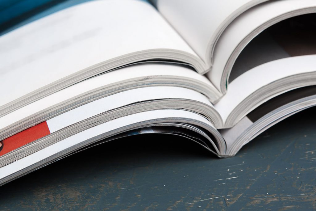 a close up photo of stacked magazines